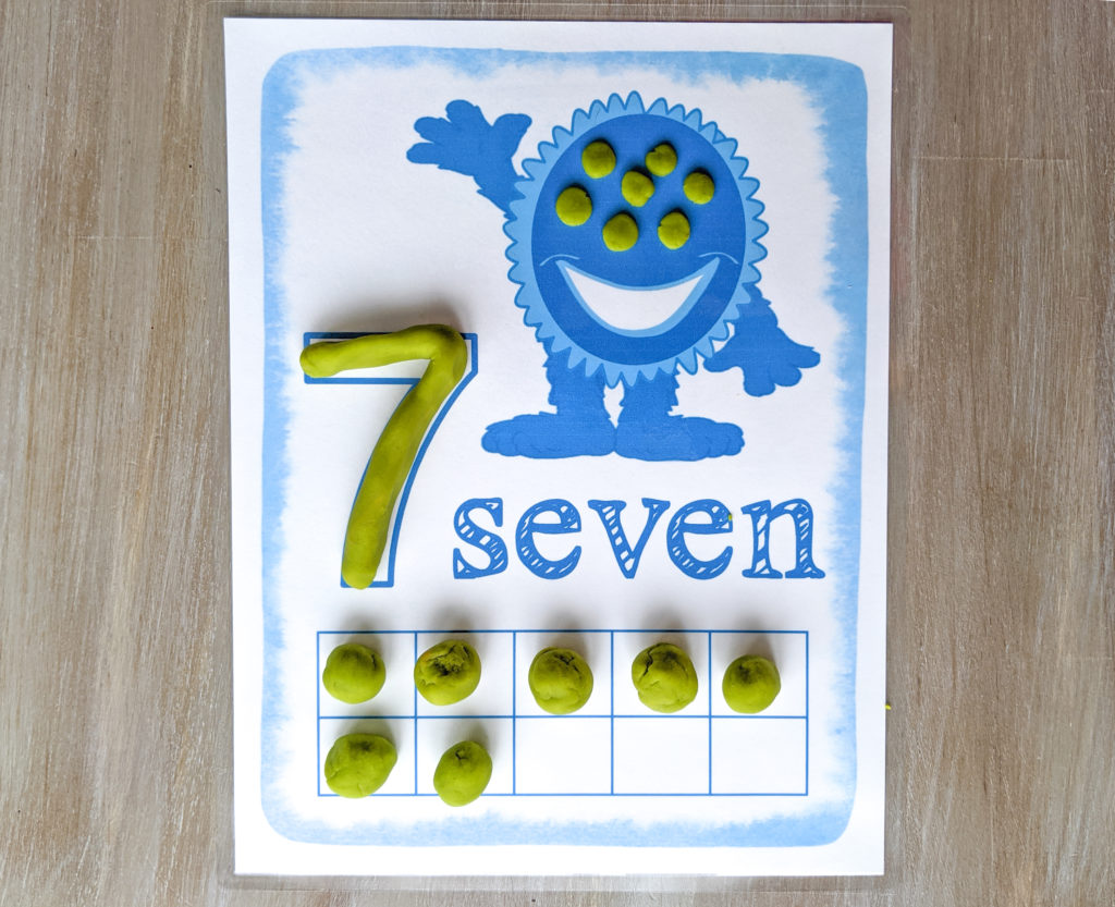 Ten frame play dough mat with the number seven on it. 