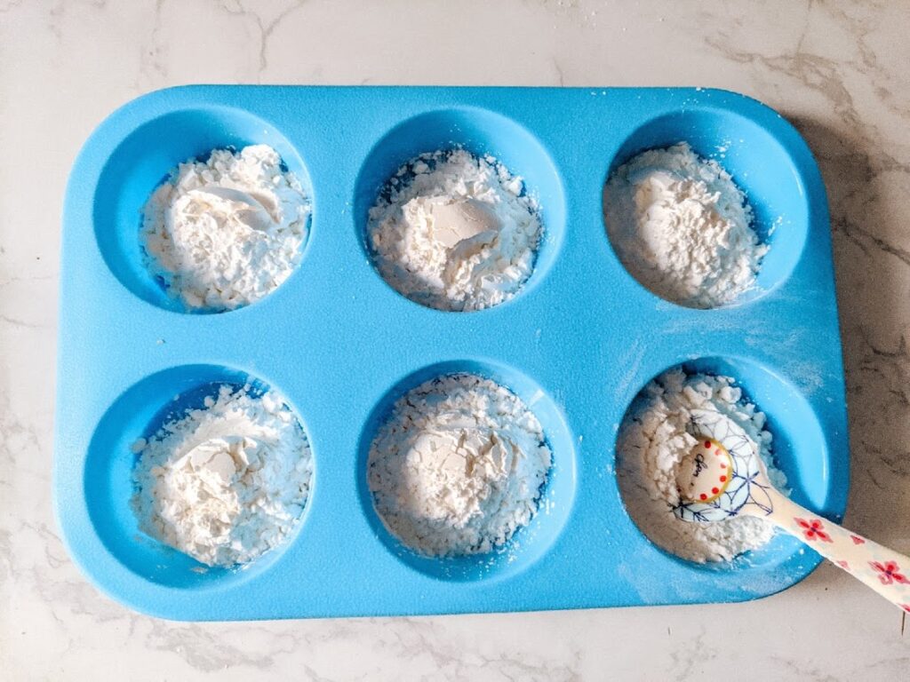Step 1 add cornstarch to the muffin tin compartments. 